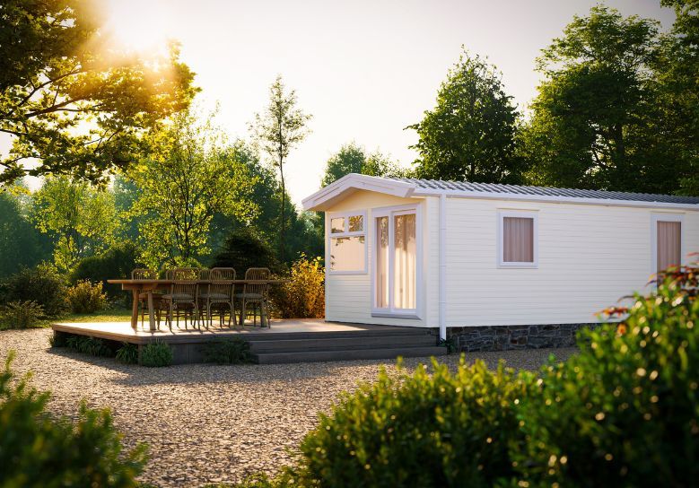 The Willerby Rio Compact exterior in light cream sited on a secluded stone area.