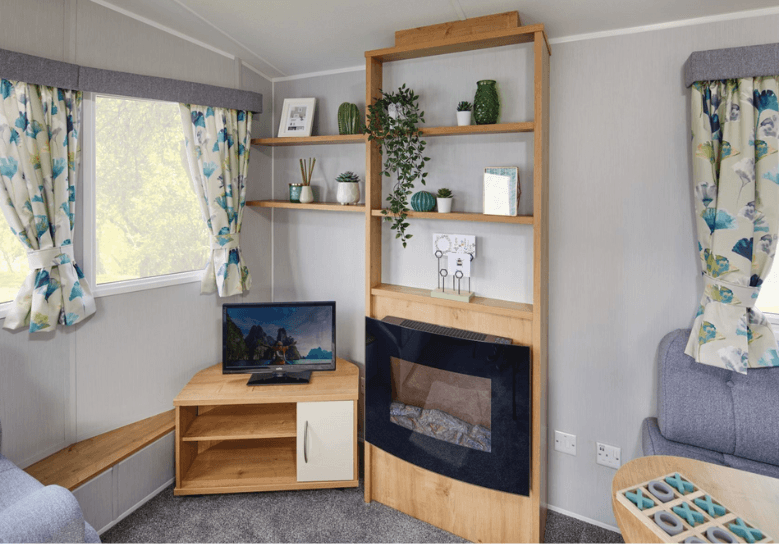 The Willerby Ashurst oak effect media unit with shelving and an electric fire.