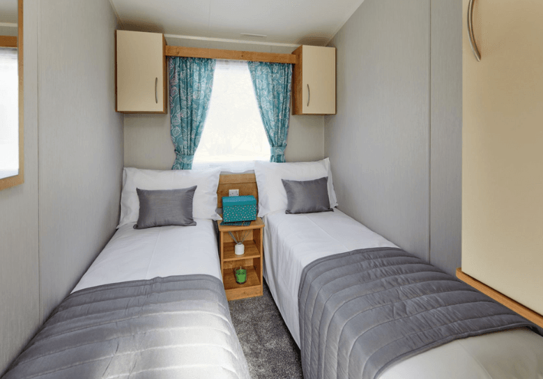 The Willerby Ashurst twin bedroom with oak effect storage units and cream cabinet doors.