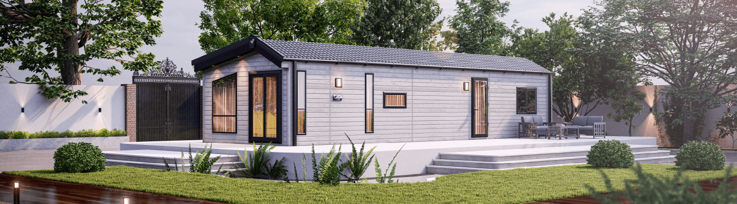 The Willerby Astoria exterior in grey with white decking placed in a beautiful garden.