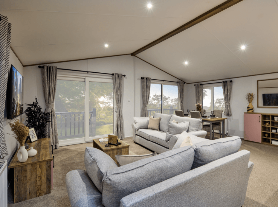 The Willerby Boston lounge with two grey freestanding sofas, a dark oak effect media unit and a matching coffee table.