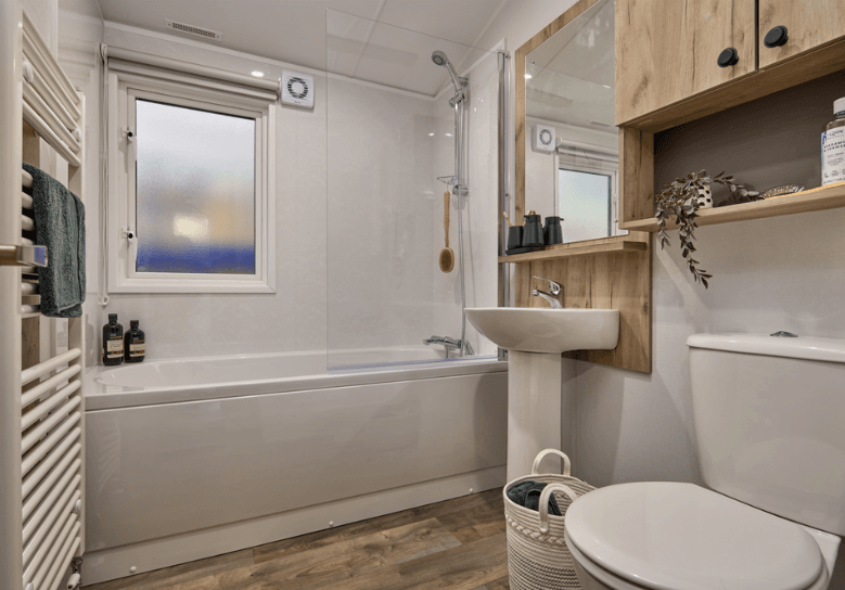 The Willerby Buxton bathroom with oak wood effect storage units with an optional bath.