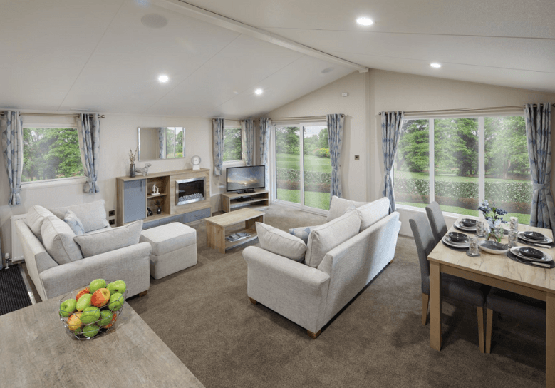 The Willerby Clearwater view of the open plan layout lounge and the dining area, with plenty of windows allowing light in.