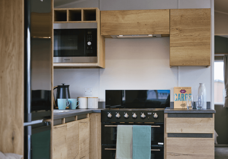 Ellerton kitchen with oak units and black appliances.