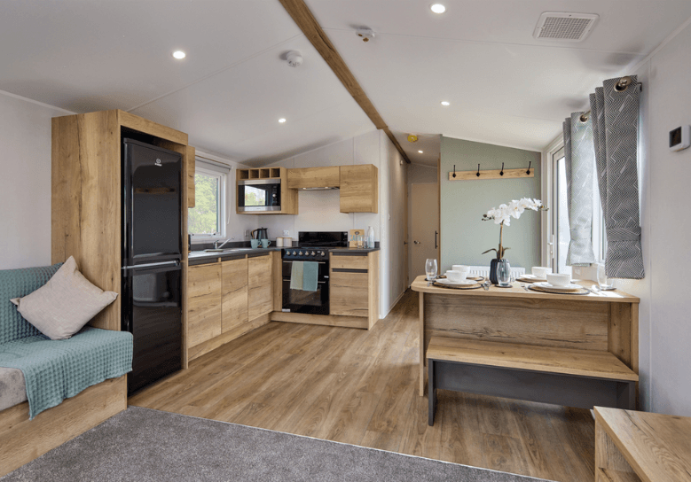 Ellerton kitchen and dining area with oak units and black appliances.