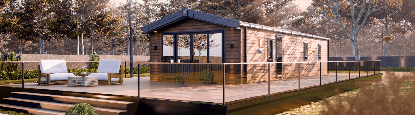 The Willerby Gainsborough exterior in brown is sited with brown wooden decking on a field.