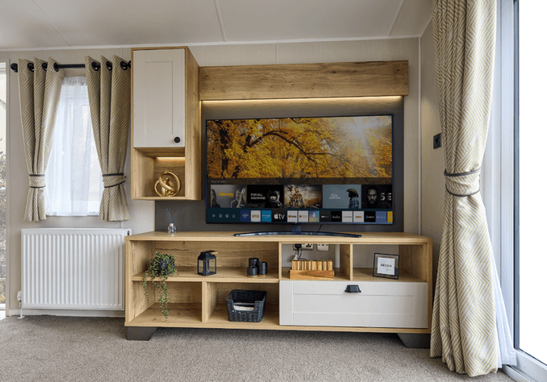 Gainsborough media lounge with oak storage units with white cupboard doors.