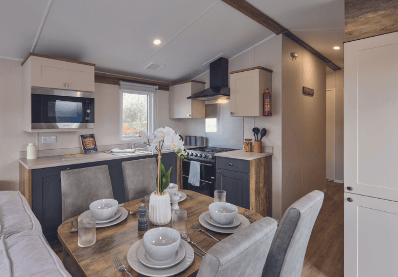 Malton kitchen with cream and grey cupboard doors, cream worktop and oak surrounding the units.