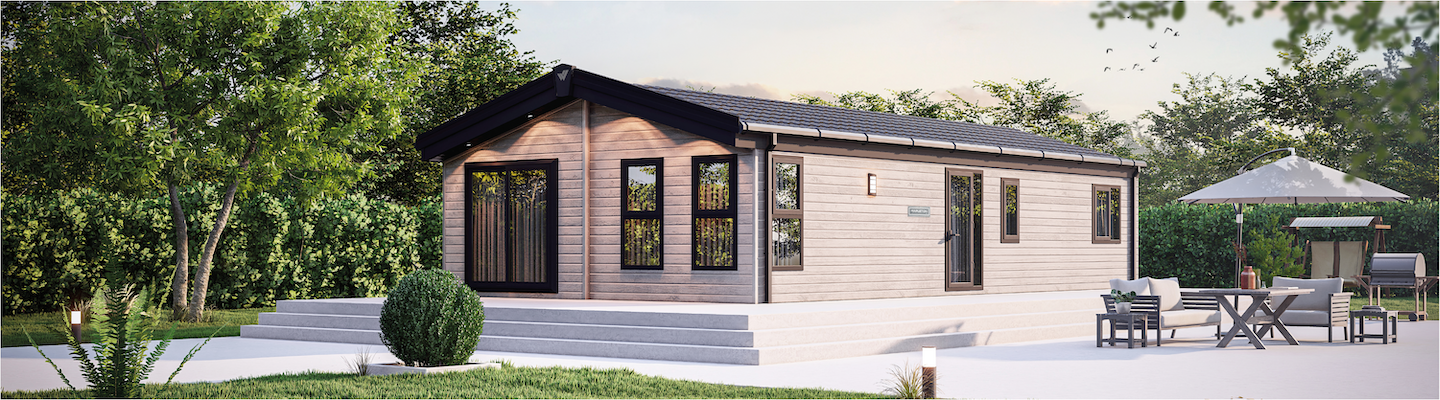 The Willerby Mapleton exterior with white decking on a field. 