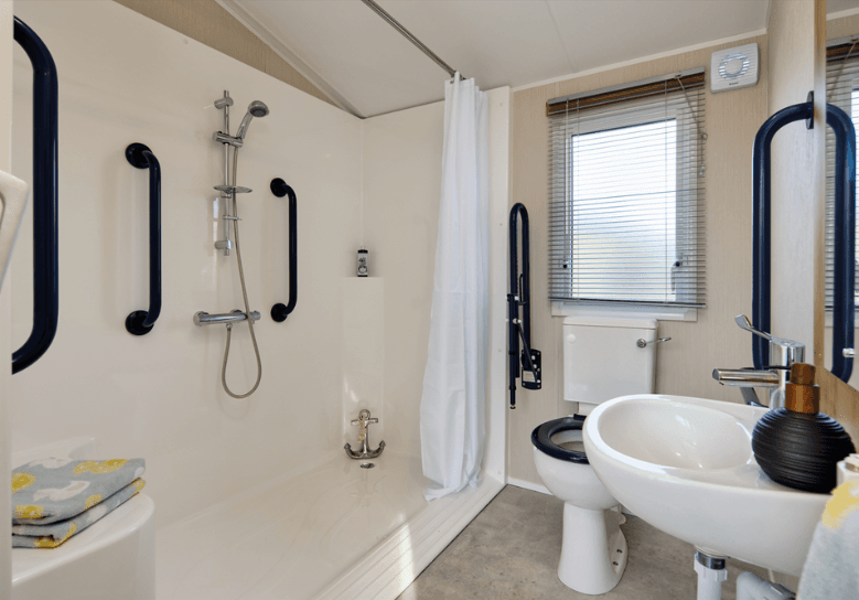 Richmond bathroom with an accessible shower pod and lots of grab rails.