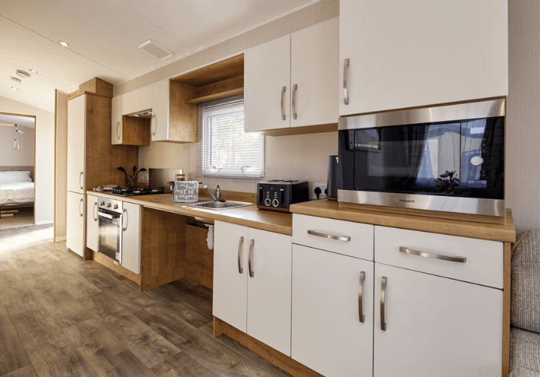 Richmond kitchen with oak units and worktop with white cupboard doors, with space under the sink perfect for wheelchair users.