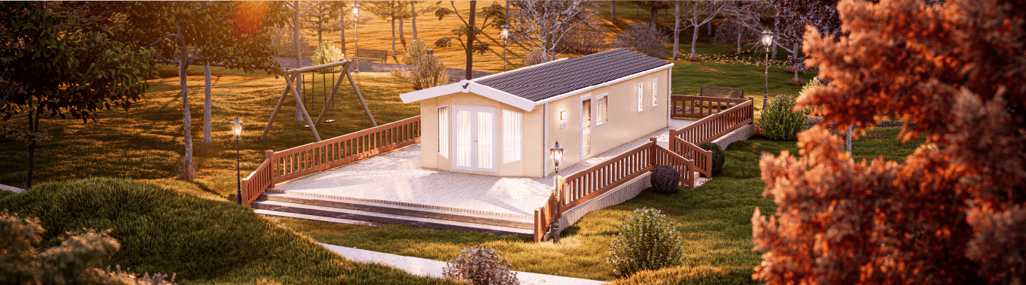 The Willerby Sierra exterior in cream on a white and brown decking surrounded by a grassy field. 