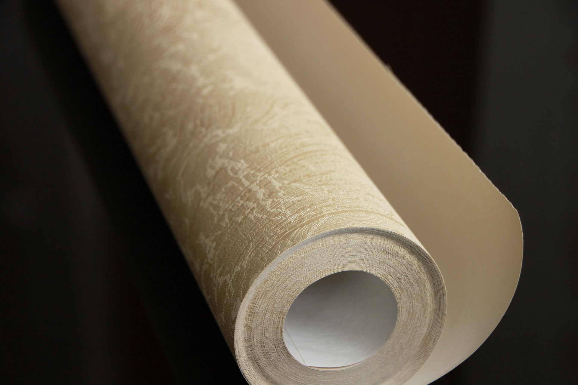 Roll of golden coloured patterned wallpaper