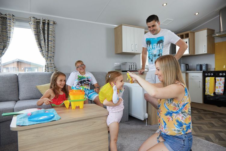 The Willerby Castleton lounge with a family of five getting ready for the beach.