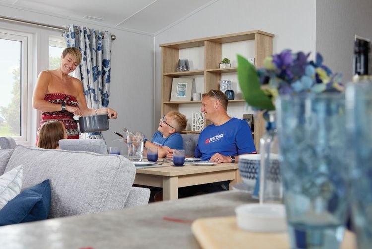 The Willerby Pinehurst dining area with a family of four sitting at the table getting ready for their tea.