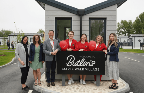 Willerby and Butlin's staff by the welcome sign at the new Maple Walk Village.