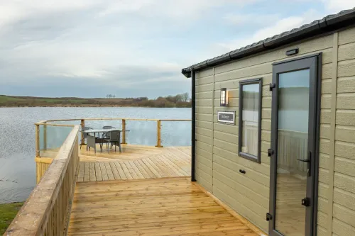 External view of the first all-electric Willerby Dorchester overlooking a Cumbrian lake.